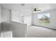 Upstairs loft space featuring carpet, natural light, and a ceiling fan at 1506 Lenton Rose Ct, Trinity, FL 34655