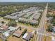 Close aerial view showcasing a modern apartment complex near local shops, surrounded by residential homes and lush greenery at 1510 Blue Sea St, Clearwater, FL 33756