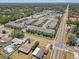Aerial view showcasing a modern apartment complex near local shops, surrounded by residential homes and lush greenery at 1510 Blue Sea St, Clearwater, FL 33756