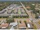 Close aerial view showcasing a modern apartment complex near local shops, surrounded by residential homes and lush greenery at 1510 Blue Sea St, Clearwater, FL 33756