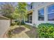 Beautiful backyard featuring lush landscaping, a screen lanai, and a privacy fence at 1510 Blue Sea St, Clearwater, FL 33756
