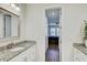 Bright bathroom offers a glimpse into the bedroom featuring marble counters, tile floors, and a calm ambiance at 1510 Blue Sea St, Clearwater, FL 33756