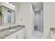 Bright bathroom featuring granite countertops, marble floors, and a stylish glass shower at 1510 Blue Sea St, Clearwater, FL 33756