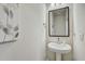 A modern bathroom with pedestal sink, stylish mirror, and neutral decor complements the clean design at 1510 Blue Sea St, Clearwater, FL 33756