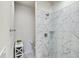 A modern bathroom featuring marble tile, a glass shower, and updated fixtures at 1510 Blue Sea St, Clearwater, FL 33756