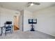 Spacious bedroom featuring a dedicated workspace, mounted television, and a view to the hallway at 1510 Blue Sea St, Clearwater, FL 33756