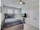 Cozy bedroom with a large bed, two windows offering natural light, and a ceiling fan at 1510 Blue Sea St, Clearwater, FL 33756