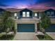 Beautiful townhome with a two-car garage and manicured landscaping, creating curb appeal at 1510 Blue Sea St, Clearwater, FL 33756