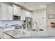 Bright kitchen featuring white cabinets, granite countertops, and stainless-steel appliances at 1510 Blue Sea St, Clearwater, FL 33756
