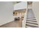 An open space featuring stairs, kitchen view, and neutral colors providing a great room to relax and entertain at 1510 Blue Sea St, Clearwater, FL 33756