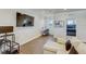 Spacious loft area with wood floors, a large television, and a glimpse into a cozy bedroom at 1510 Blue Sea St, Clearwater, FL 33756
