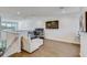 Bright loft featuring modern design, wood floors, and a comfortable seating area with a large wall-mounted television at 1510 Blue Sea St, Clearwater, FL 33756