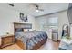 Cozy main bedroom featuring wood floors, a large bed with storage, and two bright windows at 1510 Blue Sea St, Clearwater, FL 33756
