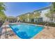 Community pool surrounded by comfortable lounge seating, trees and beautiful landscaping at 1510 Blue Sea St, Clearwater, FL 33756