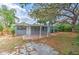 Spacious backyard featuring a covered patio and mature trees at 1511 Meridel Ave, Tampa, FL 33612