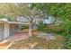 A backyard featuring a covered patio with brick flooring and mature landscaping at 1511 Meridel Ave, Tampa, FL 33612