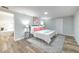 Bright bedroom featuring a large bed, stylish rug, and an ensuite bathroom with a luxurious soaking tub at 1511 Meridel Ave, Tampa, FL 33612