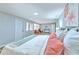 Bright and airy bedroom with neutral decor, lots of windows, and a cozy sitting area with an orange chair at 1511 Meridel Ave, Tampa, FL 33612