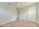 Neutral bedroom featuring wood floors, and a ceiling fan and white door to hallway at 1511 Meridel Ave, Tampa, FL 33612