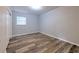 Bedroom with a closet, window, and wood-look flooring at 1511 Meridel Ave, Tampa, FL 33612