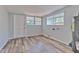 Large bonus room with wood-look floors, great natural light, and an exterior door at 1511 Meridel Ave, Tampa, FL 33612