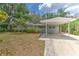 Lovely single-story home with a carport, features mature landscaping and a welcoming front lawn at 1511 Meridel Ave, Tampa, FL 33612