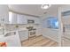 A kitchen featuring white cabinets, stainless steel appliances, and an open view to the living room at 1511 Meridel Ave, Tampa, FL 33612