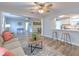 Open-concept living space with wood-look flooring and views of the kitchen and dining area at 1511 Meridel Ave, Tampa, FL 33612