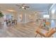 Open-concept living room with updated flooring, ceiling fans, and ample natural light at 1511 Meridel Ave, Tampa, FL 33612