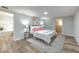 Well-lit main bedroom featuring wood-look flooring and access to the ensuite bathroom at 1511 Meridel Ave, Tampa, FL 33612