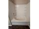 Bathroom bathtub featuring shower head, built-in shelves, and tile surround at 1530 Villa Capri Cir # 302, Odessa, FL 33556
