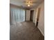 Carpeted bedroom featuring sliding glass doors, ceiling fan, and closet at 1530 Villa Capri Cir # 302, Odessa, FL 33556