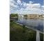 Community view with the lake, fountains, and grassy area with sidewalk at 1530 Villa Capri Cir # 302, Odessa, FL 33556