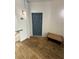 Apartment entryway with wood floors, a blue door, and a bench at 1530 Villa Capri Cir # 302, Odessa, FL 33556