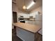 Bright kitchen features white cabinetry, island, and modern appliances at 1530 Villa Capri Cir # 302, Odessa, FL 33556