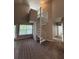 Spacious living room with a spiral staircase and windows offering an abundance of natural light at 1530 Villa Capri Cir # 302, Odessa, FL 33556