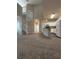 Spacious living area showcasing a spiral staircase and modern kitchen with island at 1530 Villa Capri Cir # 302, Odessa, FL 33556