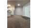 Cozy living area with modern kitchen featuring white cabinetry and island at 1530 Villa Capri Cir # 302, Odessa, FL 33556