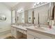 Well-lit bathroom features double sinks, a large mirror, and clean white cabinetry at 17616 Nathans Dr, Tampa, FL 33647