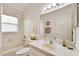 Bright bathroom featuring a shower-tub combo, a large mirror, and ample counter space at 17616 Nathans Dr, Tampa, FL 33647