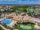 An aerial view of a building complex with a pool, lawns, and golf course nearby at 1823 Atrium Dr, Sun City Center, FL 33573