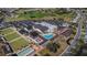 Aerial view of community featuring buildings, parking lots, pool, and greens at 1823 Atrium Dr, Sun City Center, FL 33573