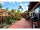 Landscaped back patio featuring red concrete, a privacy fence, and a grill at 1823 Atrium Dr, Sun City Center, FL 33573