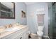 Bathroom featuring a vanity, toilet, and shower with gray walls at 1823 Atrium Dr, Sun City Center, FL 33573