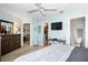 Spacious bedroom featuring wood-look floors and a television mounted on the wall at 1823 Atrium Dr, Sun City Center, FL 33573