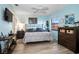 A light-filled bedroom featuring a ceiling fan, wood-look flooring, and light blue walls at 1823 Atrium Dr, Sun City Center, FL 33573