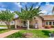 A library exterior surrounded by green grass, trees, and plants at 1823 Atrium Dr, Sun City Center, FL 33573