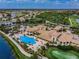 Aerial view of the community clubhouse and pool area, surrounded by beautiful landscaping and recreational spaces at 1823 Atrium Dr, Sun City Center, FL 33573