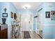 Bright foyer with wood floors and a decorative mirror, and blue accent walls at 1823 Atrium Dr, Sun City Center, FL 33573