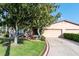 Inviting single-story home with a two-car garage and manicured landscaping at 1823 Atrium Dr, Sun City Center, FL 33573